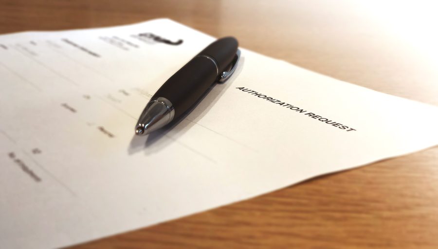 Pen on a pre-authorized debit agreement on a desk