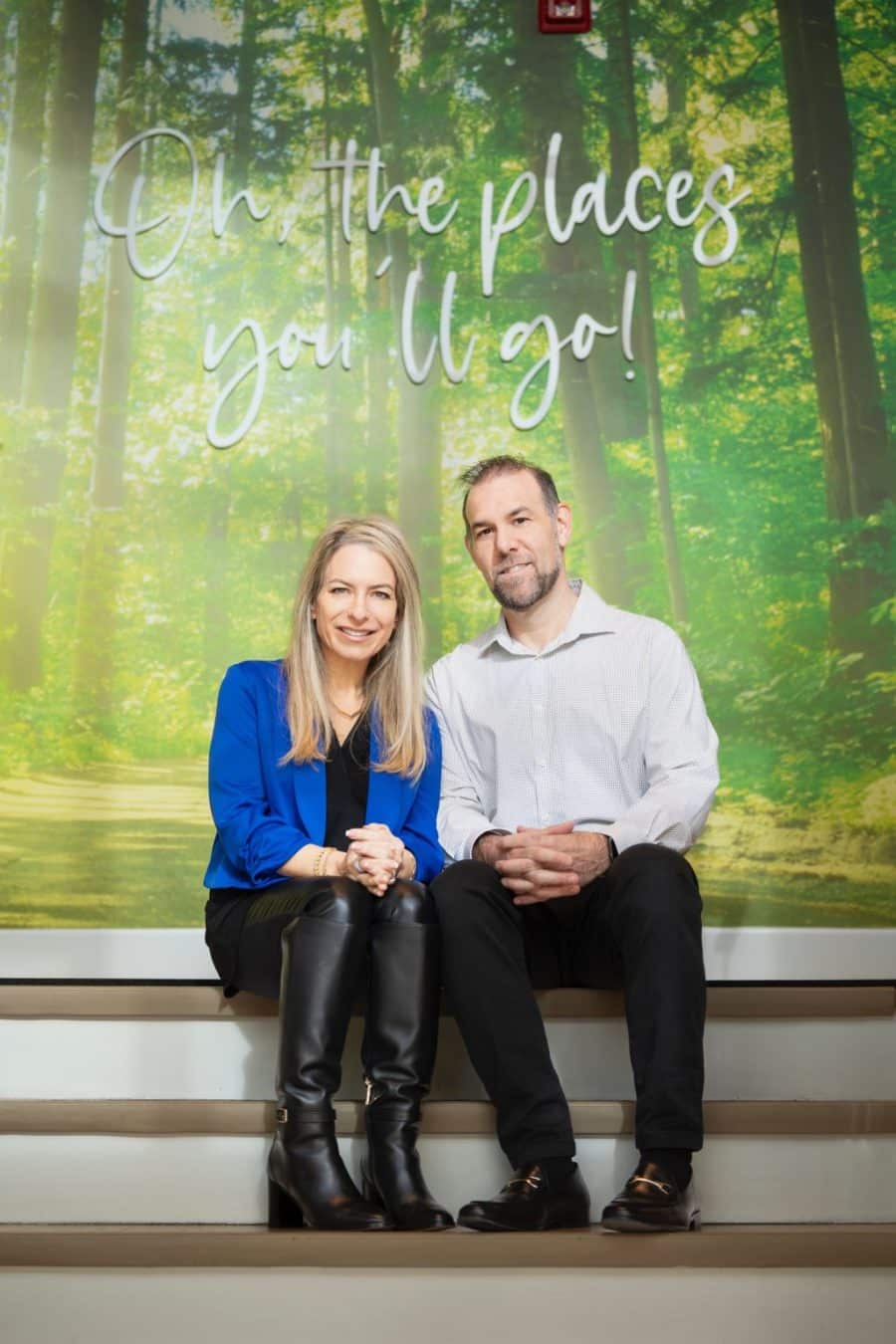 Tami and Carl of The Little Campus sitting on some stairs with a graphic behind that says, "Oh, the places you'll go!"