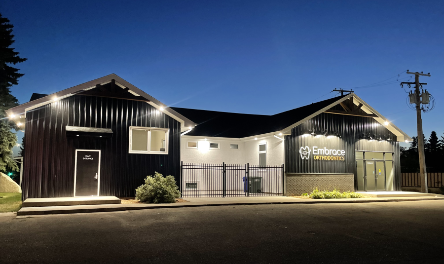 The Embrace Orthodontics building at night.