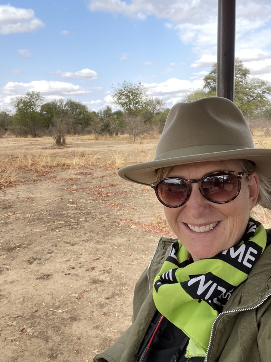 Kerry on a Jeep with safari gear going for a ride on the African plains.